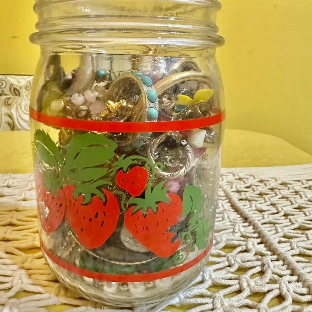 Vintage strawberry glass jar full of jewelry & junk craft trinkets.